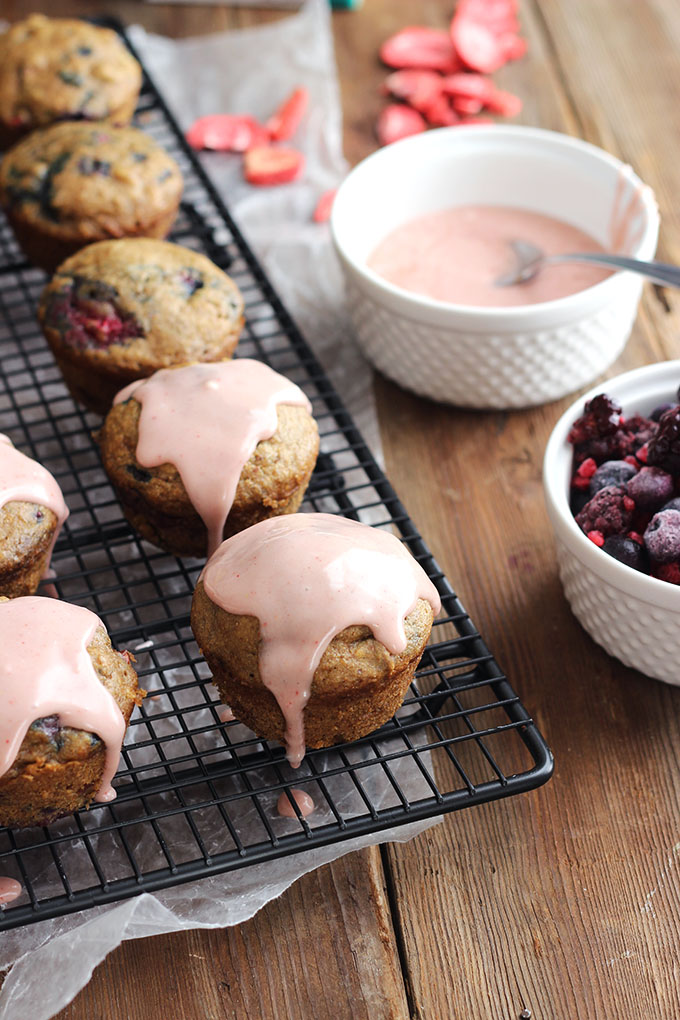 Vegan Berry Muffins with pink glaze on a cooling rack. 